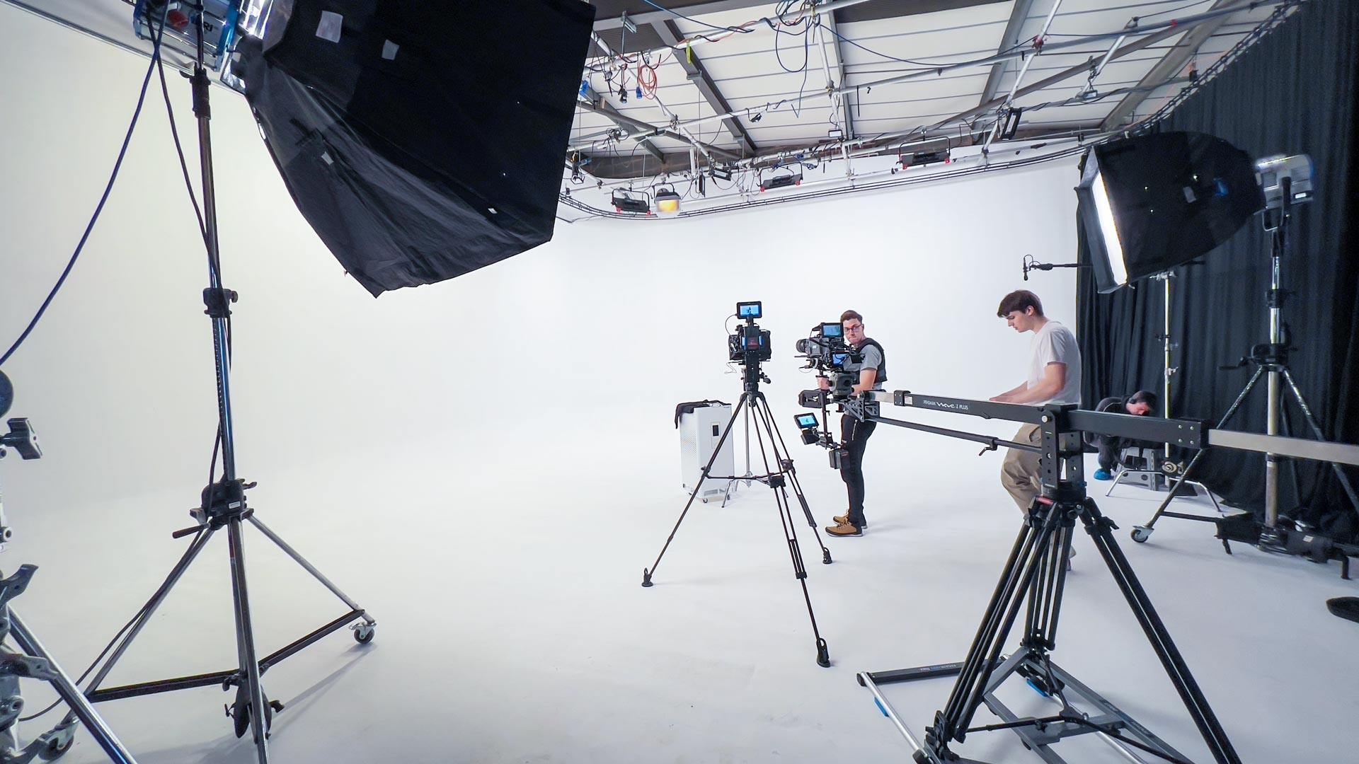 Photography equipment setup in Cineview Studios Infinity Cove with lighting grid