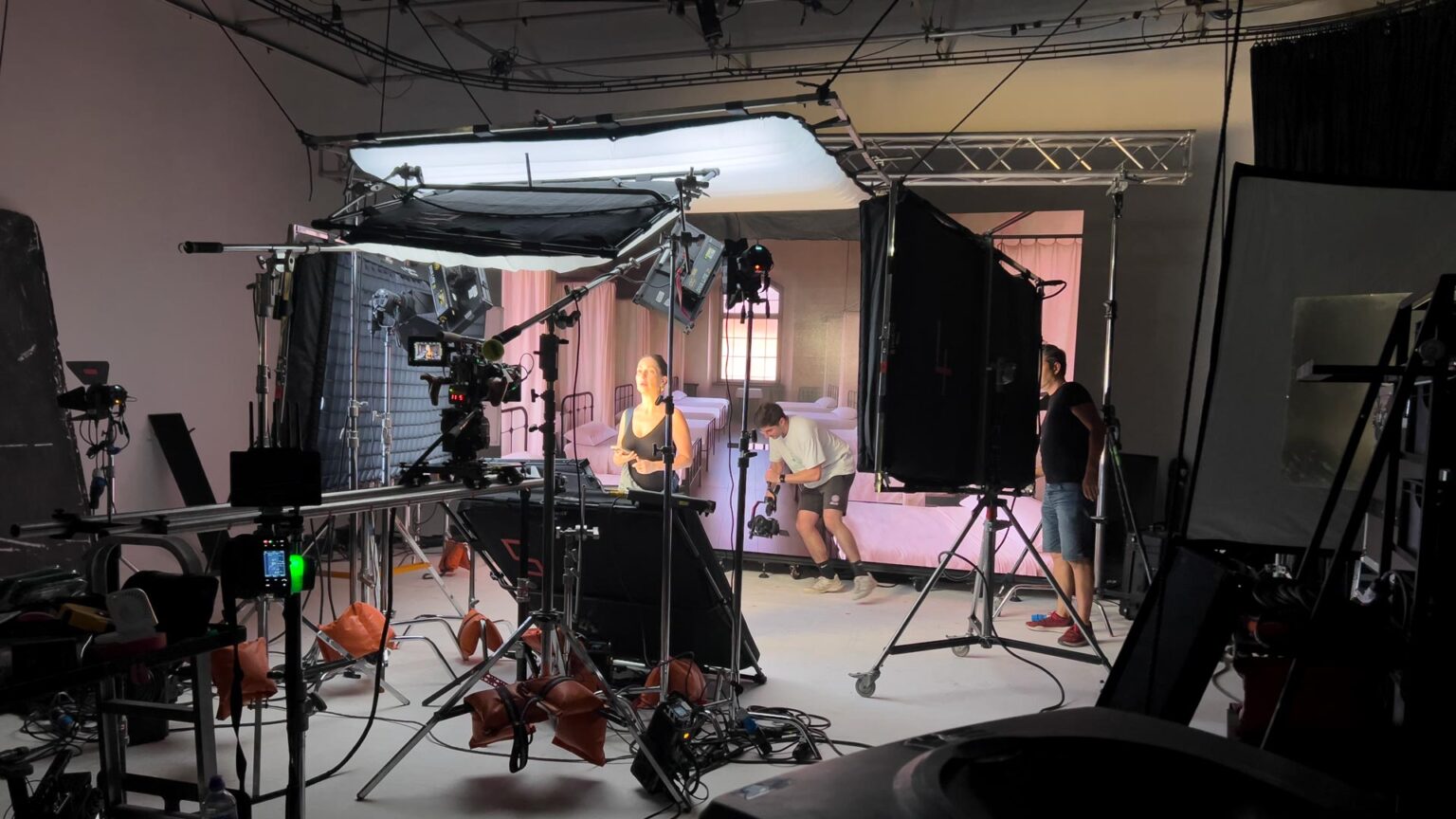 Creative film production team working in a modern studio environment during video filming